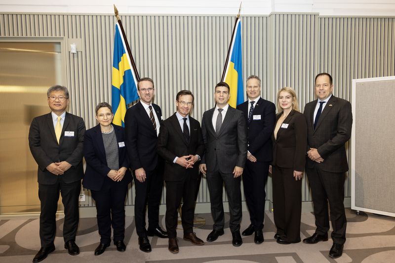 Ministers and senior officials gathered in front of Swedish and Ukrainian flags